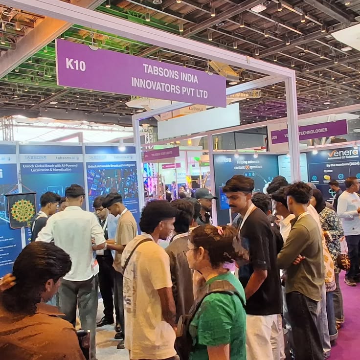 Visitors crowding around an exhibitor's stall at a business expo